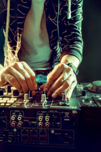 DJ playing music at mixer closeup